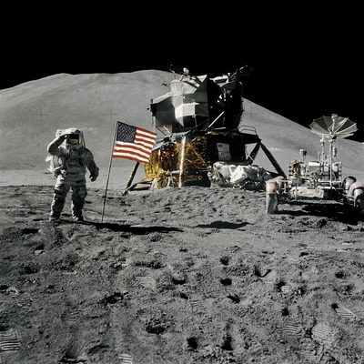 NASA photo of astronaut saluting flag with kit